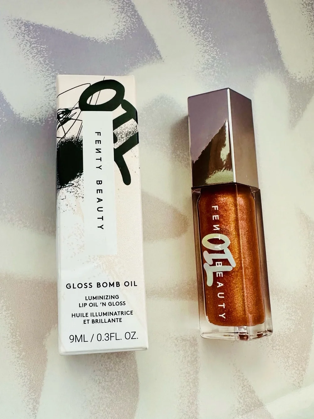 Fenty Beauty Gloss Bomb Lip Gloss in Frosted Bunz Sparkling Amber Gold